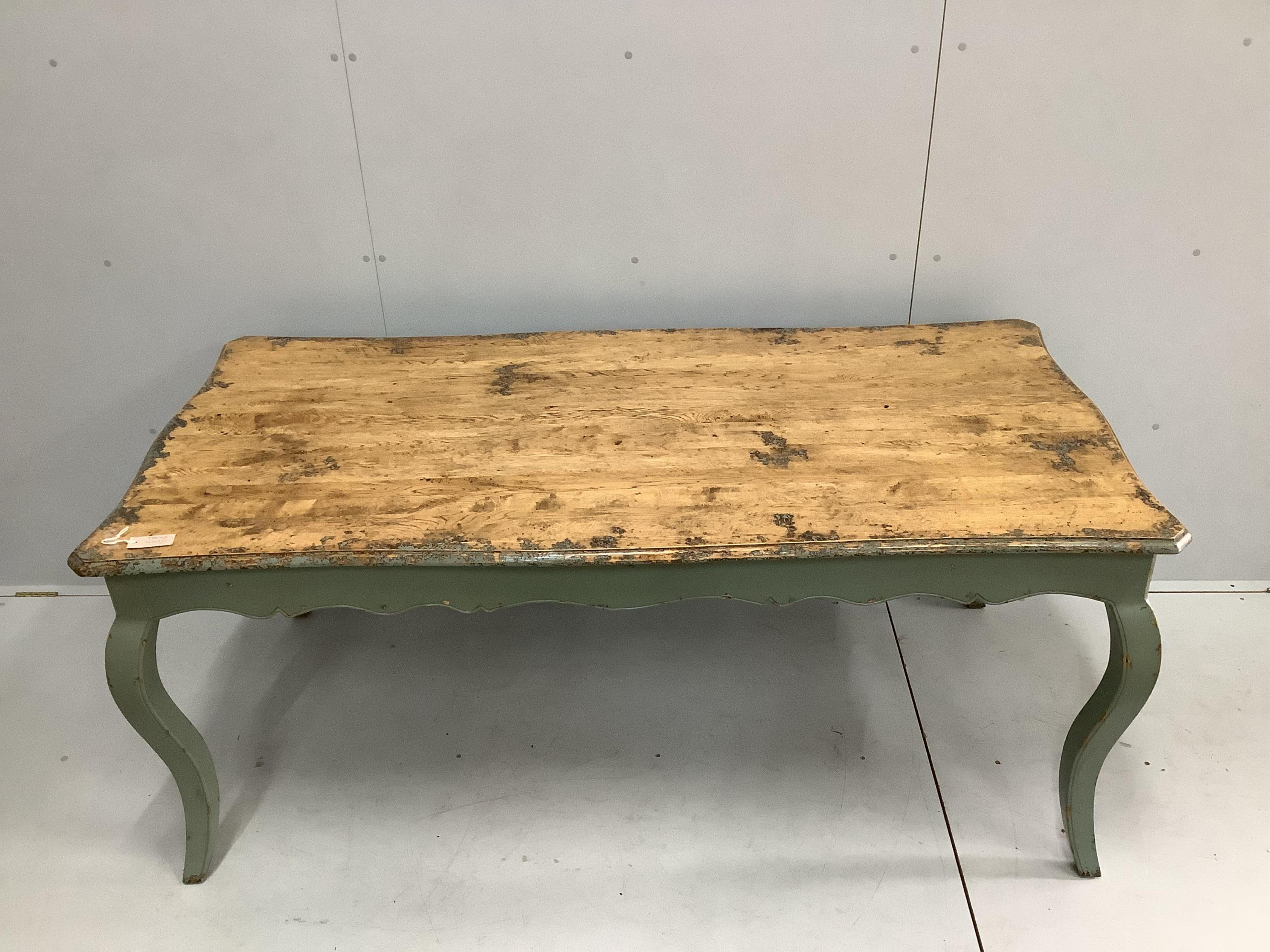 A French Provincial style part painted oak dining table, width 178cm, depth 87cm, height 77cm, together with six ladderback chairs. Condition - table good, chairs - good